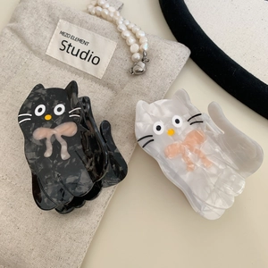 Cute acetate cat hair claws in black and cream with marble texture and bow details