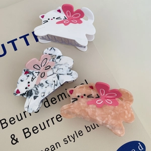 Cute acetate cat hair claws with pink bows in white and marble patterns set on card