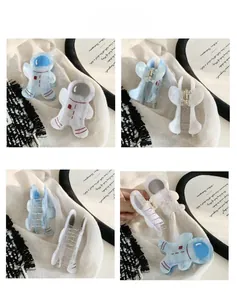 Detailed views of astronaut hair claws in blue and white with pearlescent finish