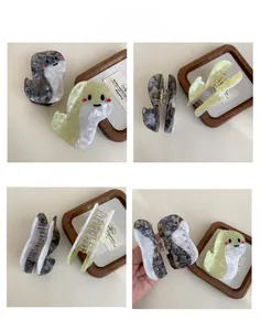 Detailed views of marbled acetate shark hair clips with strong metal spring and teeth