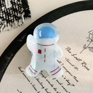 Macro shot of cute astronaut hair claw made of pearlescent acetate material