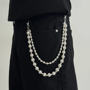 Double-layered beaded hip hop pant chain with metallic disco-ball texture on black jeans