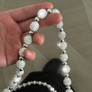 Detailed macro view of iced out silver disco ball beads on a luxury hip hop wallet chain