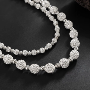 Macro shot of double-layered hip hop chain with iced-out rhinestone beads and silver balls