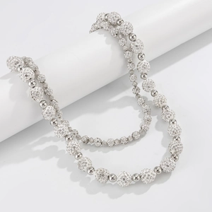 Detail of double-layer beaded chain with silver spheres and sparkling crystal-set charms