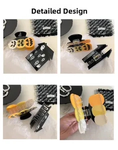 Detail view of Halloween ghost and pumpkin hair claw clips made of acetate material