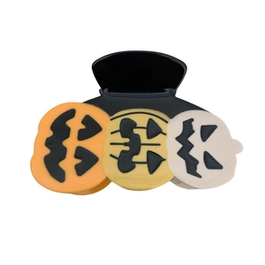 Polished black Halloween claw clip featuring three Jack-O-Lantern pumpkin face motifs
