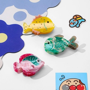 Three-piece fish-shaped acetate hair claws with sparkling rhinestones in multiple colors