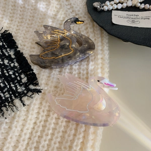 Elegant swan-shaped acetate hair claw clips in dark grey marble and pearly pink finish