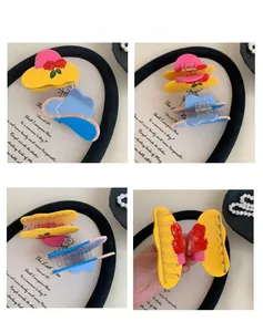 Detail of creative hat-shaped hair claw clips with floral patterns and sturdy metal spring