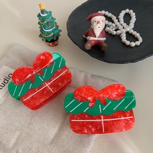 Christmas bow hair claw clips in red and green marble texture for festive styling