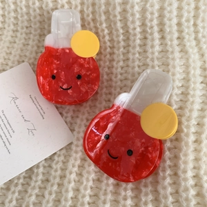 Red acetate hair claw clips with cute smiley faces and floral textures in a two-piece set