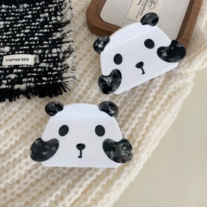Cute panda hair claw clips made of white and marbled grey acetate on knit background