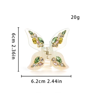 Close-up of butterfly hair claw showing 6cm size with rhinestones and metal spring