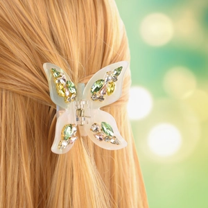 Elegant acetate butterfly hair claw clip with colorful rhinestones on blonde hair