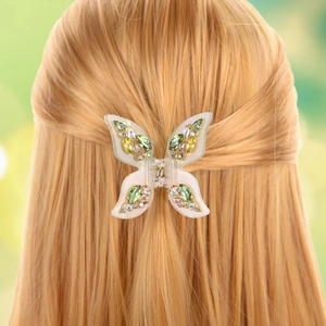 Detail of translucent butterfly hair claw with colorful crystals on blonde hair