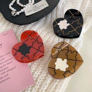 Creative heart-shaped puzzle claw clips in red, black and brown for elegant hairstyling