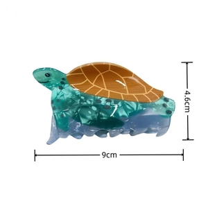 Detailed view of sea turtle hair claw clip in green marble acrylic with size dimensions