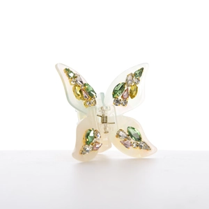 Macro detail of butterfly hair claw clip with colorful rhinestones and gold metal base