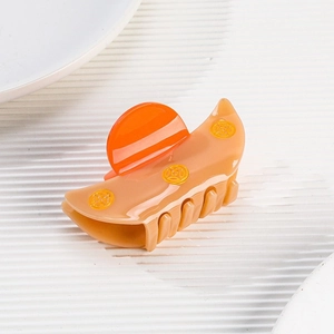 Retro fan-shaped acetate hair claw clip with golden coin patterns and light skin tones