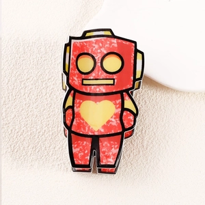 Macro detail of red cartoon robot hair claw clip with heart and polka dot pattern