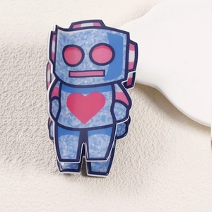 Detail of blue marble texture hair claw featuring a cute pink heart robot design