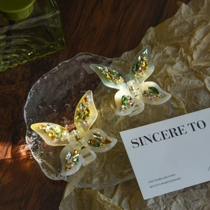 Elegant acetate butterfly hair claws with colorful rhinestones in yellow and green