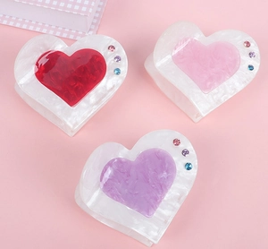 Three acrylic heart hair claws in red pink and purple with marble texture and rhinestones