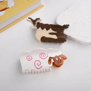 Detail view of cute acetate goat and sheep hair claws on decorative stones and books
