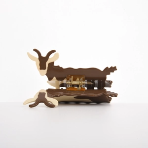 Detail of cute goat-shaped acetate hair claw clip with brown and white color contrast
