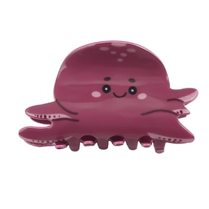 Detail of cute octopus hair claw clip in rose pink showing glossy acrylic finish