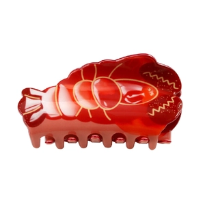 Detailed side view of a glossy red lobster-shaped hair claw clip with yellow outlines