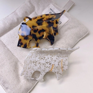 Elegant leopard-style acetate hair claws in tortoiseshell and white floral patterns