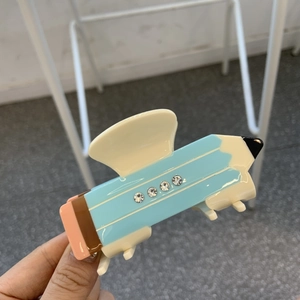 Cute pencil-shaped acetate hair claw clip with rhinestones in blue and cream patchwork