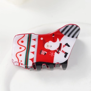 Detaillierte Nahaufnahme einer weihnachtlichen Haarklammer mit lustigem Weihnachtsmann-Motiv