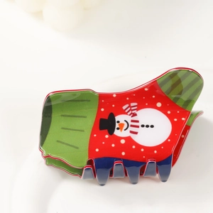 Detail der Haarklammer im Weihnachtsstrumpf-Design mit Schneemannmuster in Rot und Grün