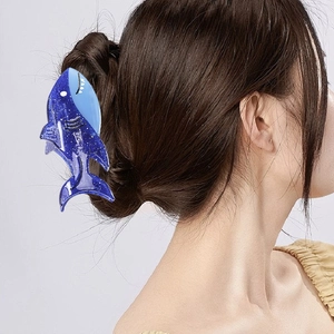 Deep blue glitter shark hair claw clip made of acetate worn on a model in a side view