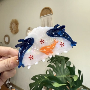 Marine life theme hair claw clip with blue dolphins and orange whale on pearly white resin