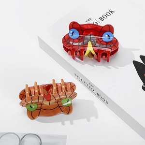 Minimalist cat shaped hair claw clips with unique patterns on a white background