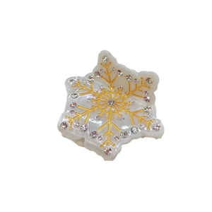 Elegant cream white snowflake hair claw with gold patterns and sparkling rhinestones