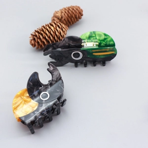 Cute acetate beetle hair claws in green and marble yellow with metal spring clip