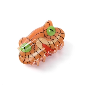 Unique snake-shaped acetate hair claw clip with orange animal pattern and green eyes