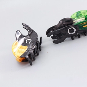 Detailed macro view of beetle hair claw clip made from premium acetate with marble texture