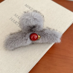 Elegant grey faux fur hair claw clip with red bead accent and gold metallic charm