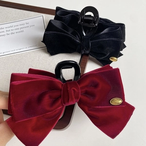 Elegant velvet bow claw clips in black and burgundy with premium gold metal logo