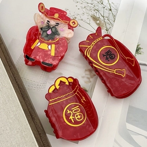 Festive acetate hair claws featuring God of Wealth and lucky bag designs in red and gold