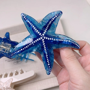 Deep blue starfish acetate hair claw clip with white marble pattern and metal spring