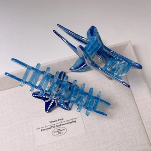 Detail of starfish hair claws in blue marble and polka dot acetate material