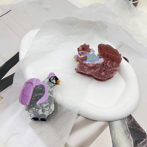 Cute squirrel and pigeon acetate hair claws with marble texture in a creative animal design