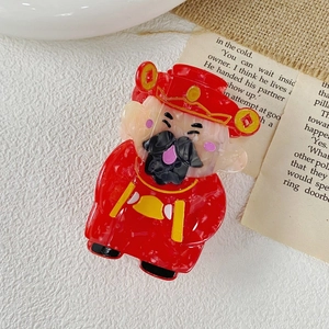 Detail of red God of Wealth acetate hair claw clip with golden coin accents